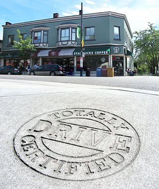 totally drive certified seal stamped in new concrete sidewalk